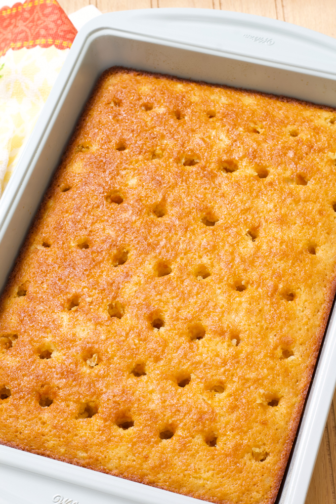 The baked cake with the holes poked in it, without the topping.