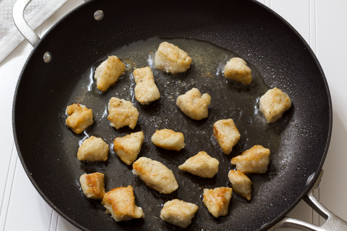 the chicken cooking in a onstick skillet.