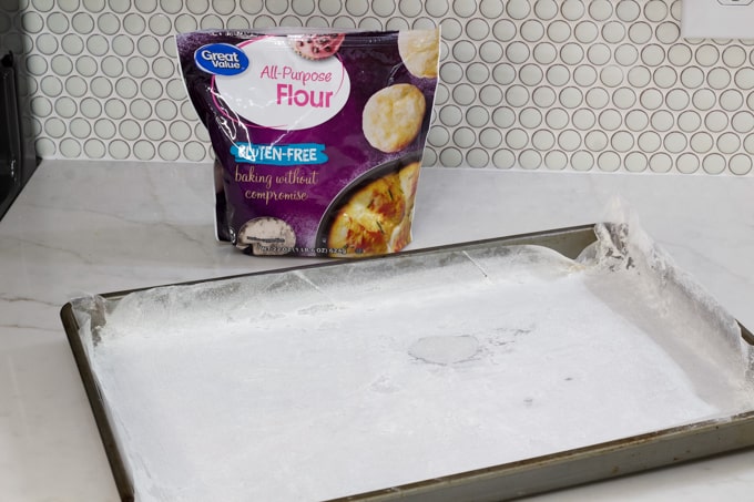 The prepared baking pan with bag of Great Value gluten free flour behind it.