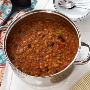 One dutch oven filled with one pot beef chili with beans.
