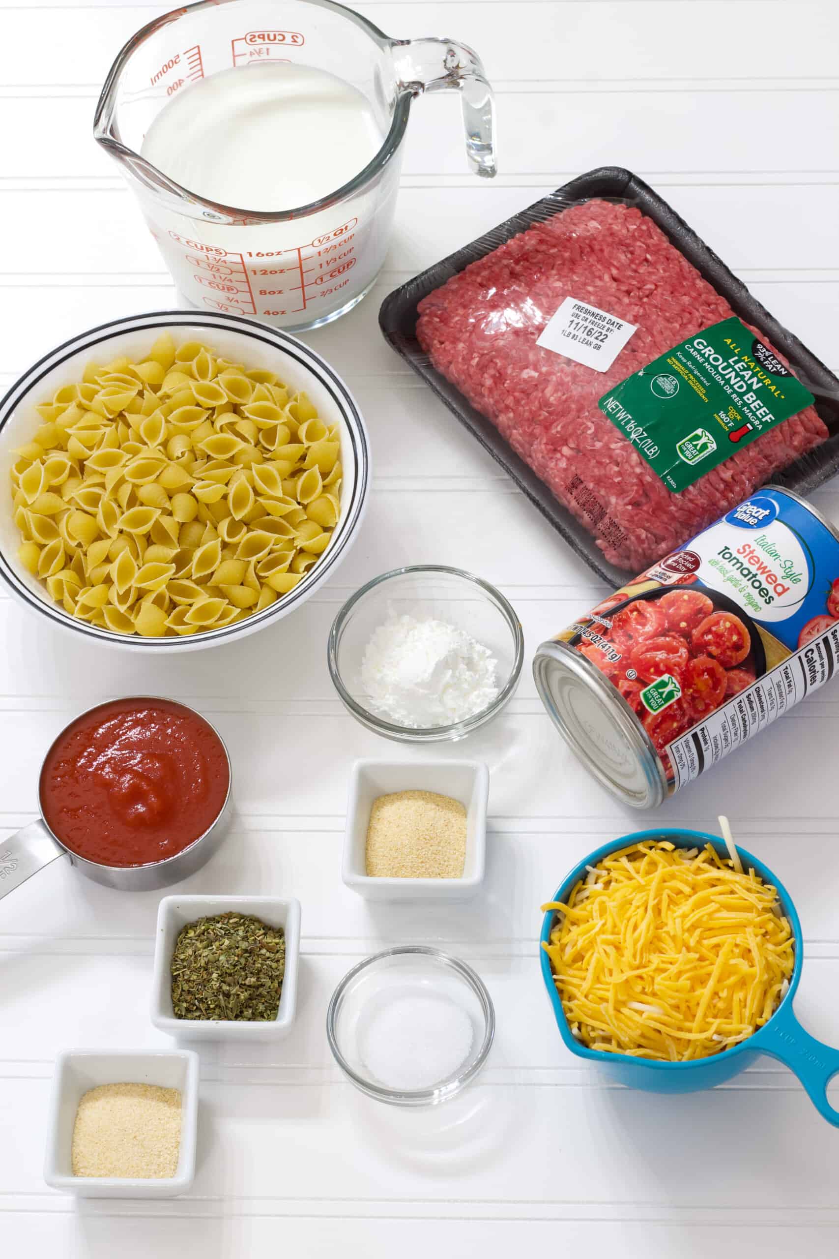 All of the ingredients needed to make the hamburger helper laid out on a table.