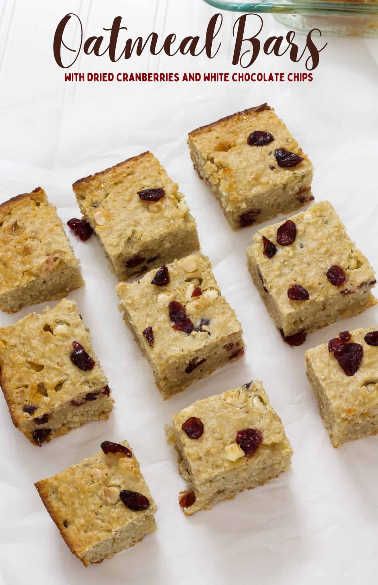 Nine oatmeal bars on white parchment paper with the recipe title written above it.
