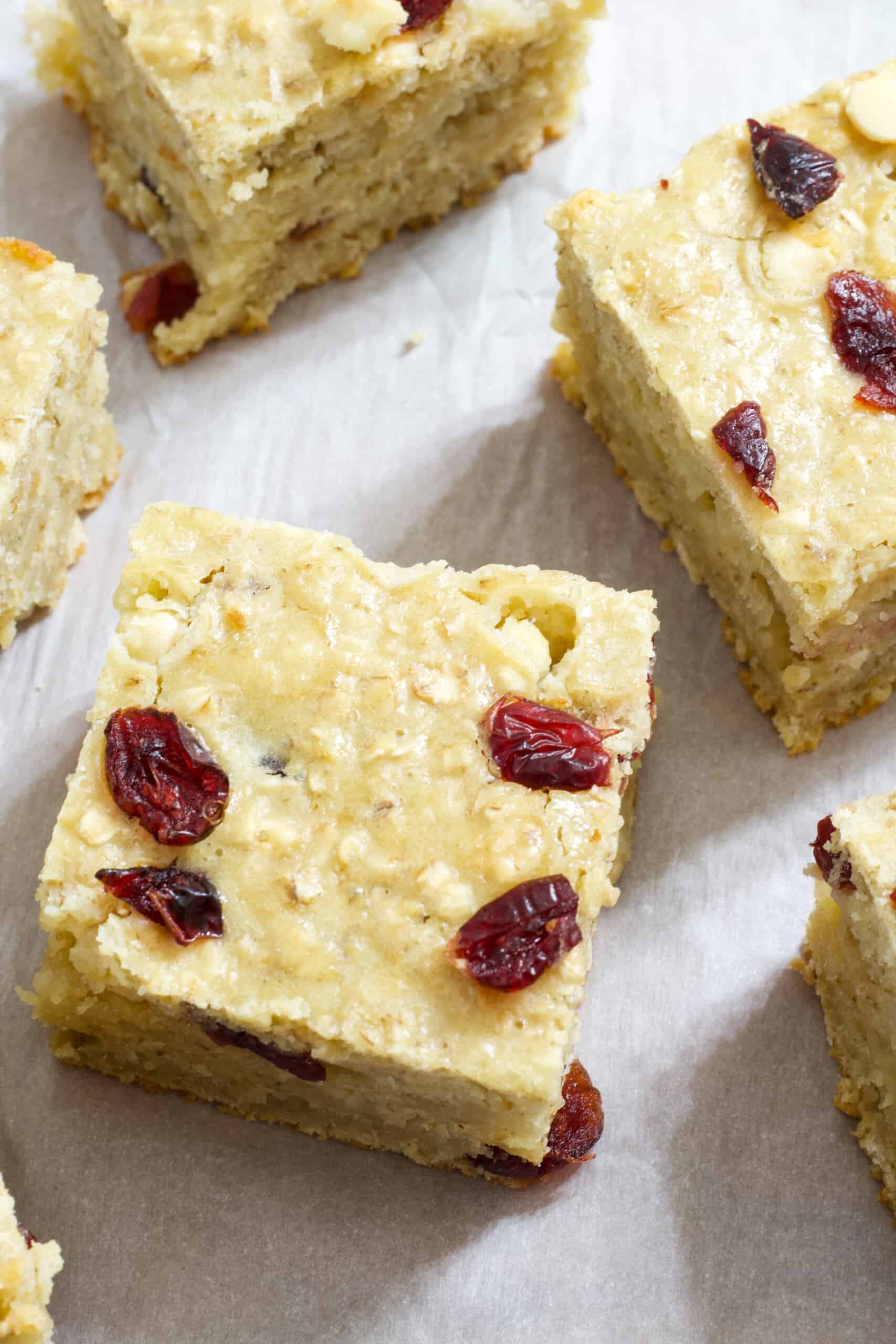 Close up view of one whole oatmeal bar with part of other bars around it.