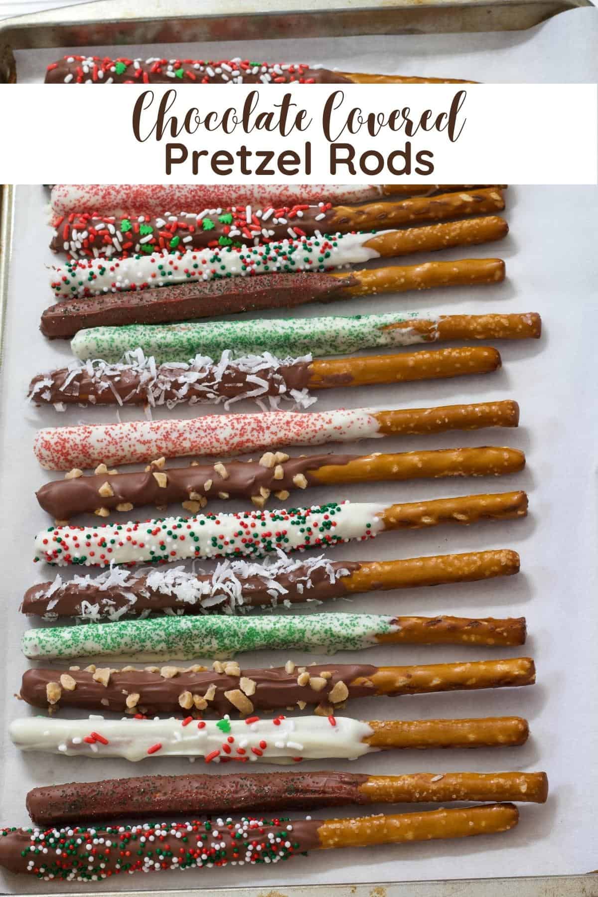 Many pretzel rods that have been dipped in chocolate and have sprinkles on them, the sprinkles are red and green for Christmas.