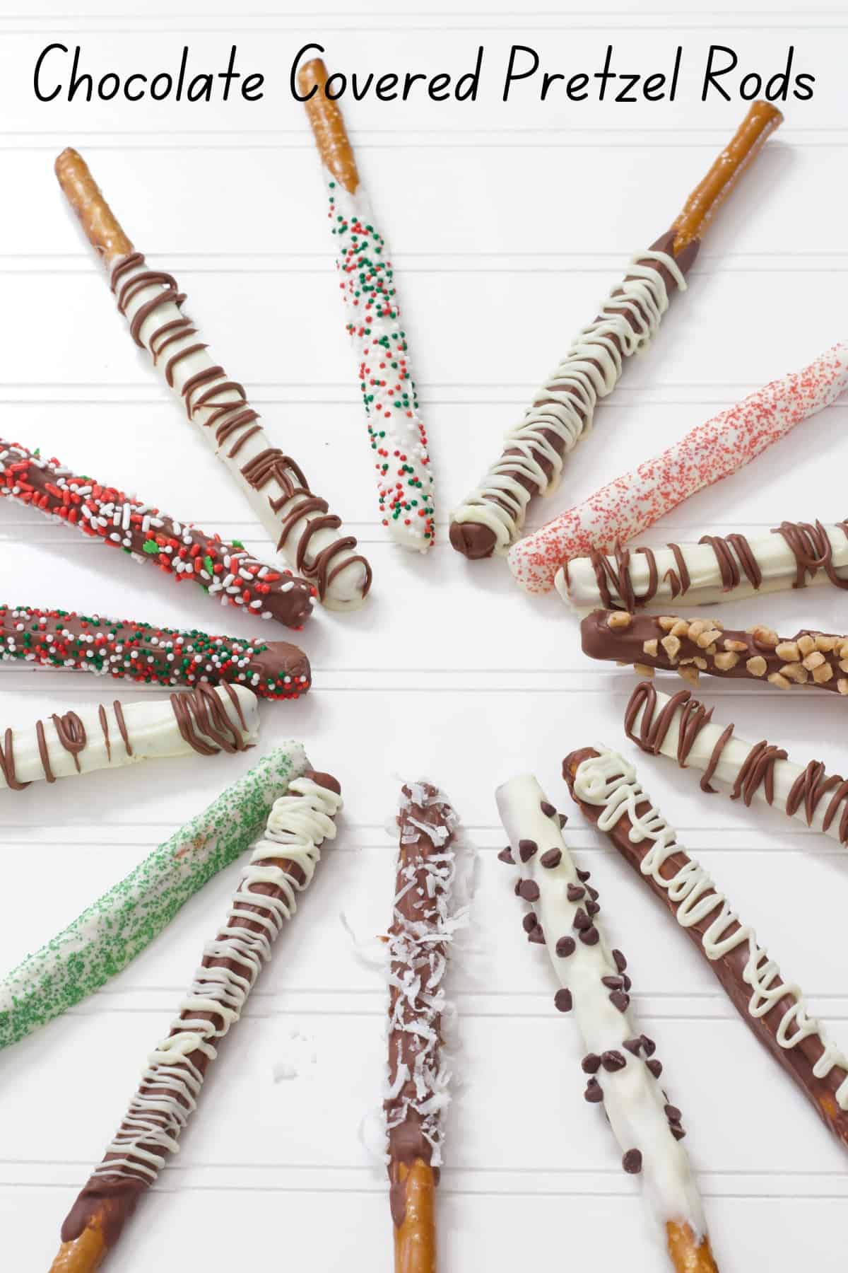 Many finished chocolate covered pretzel rods on a white background.