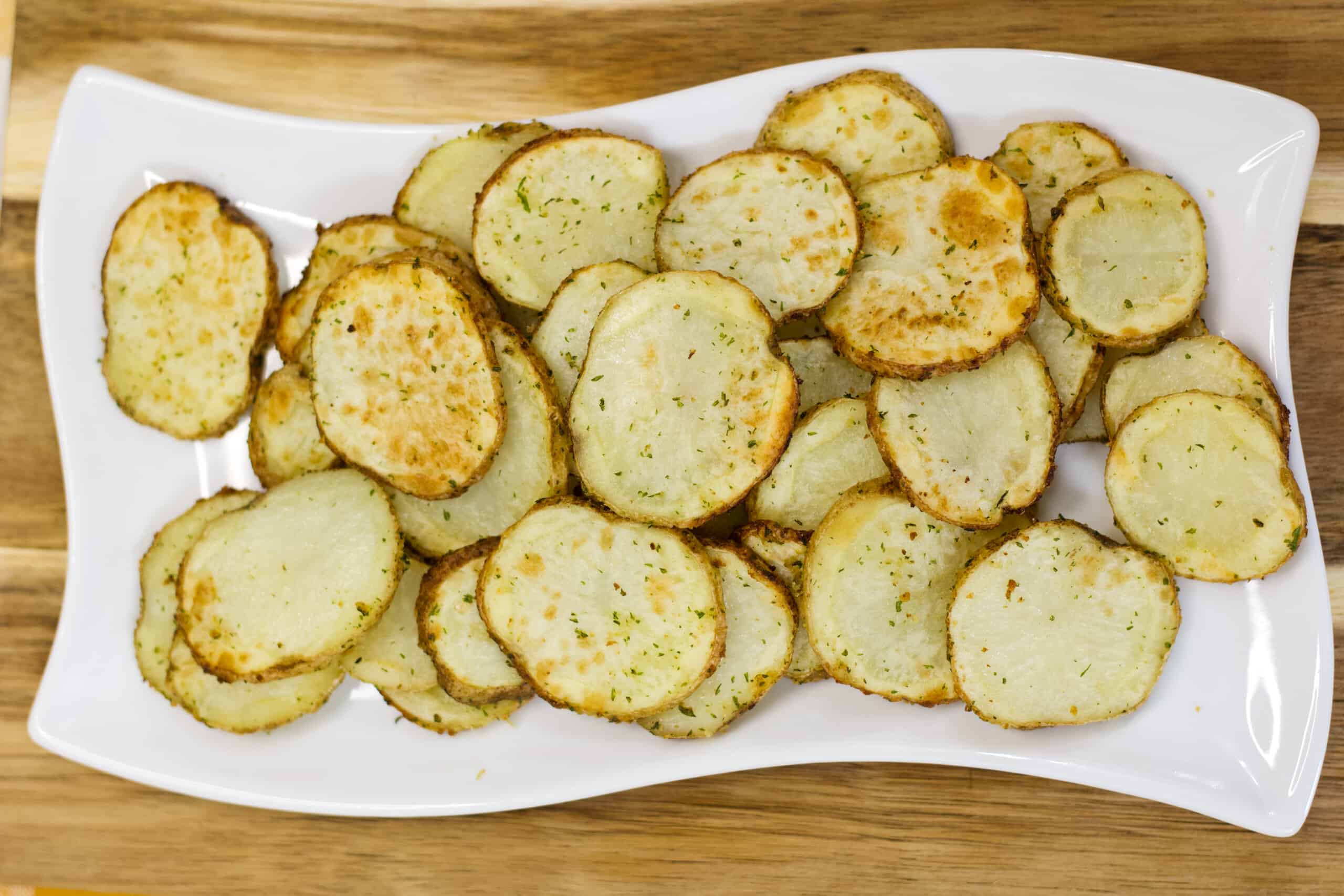 Horizontal image of the air fried potatoes on a white plate.