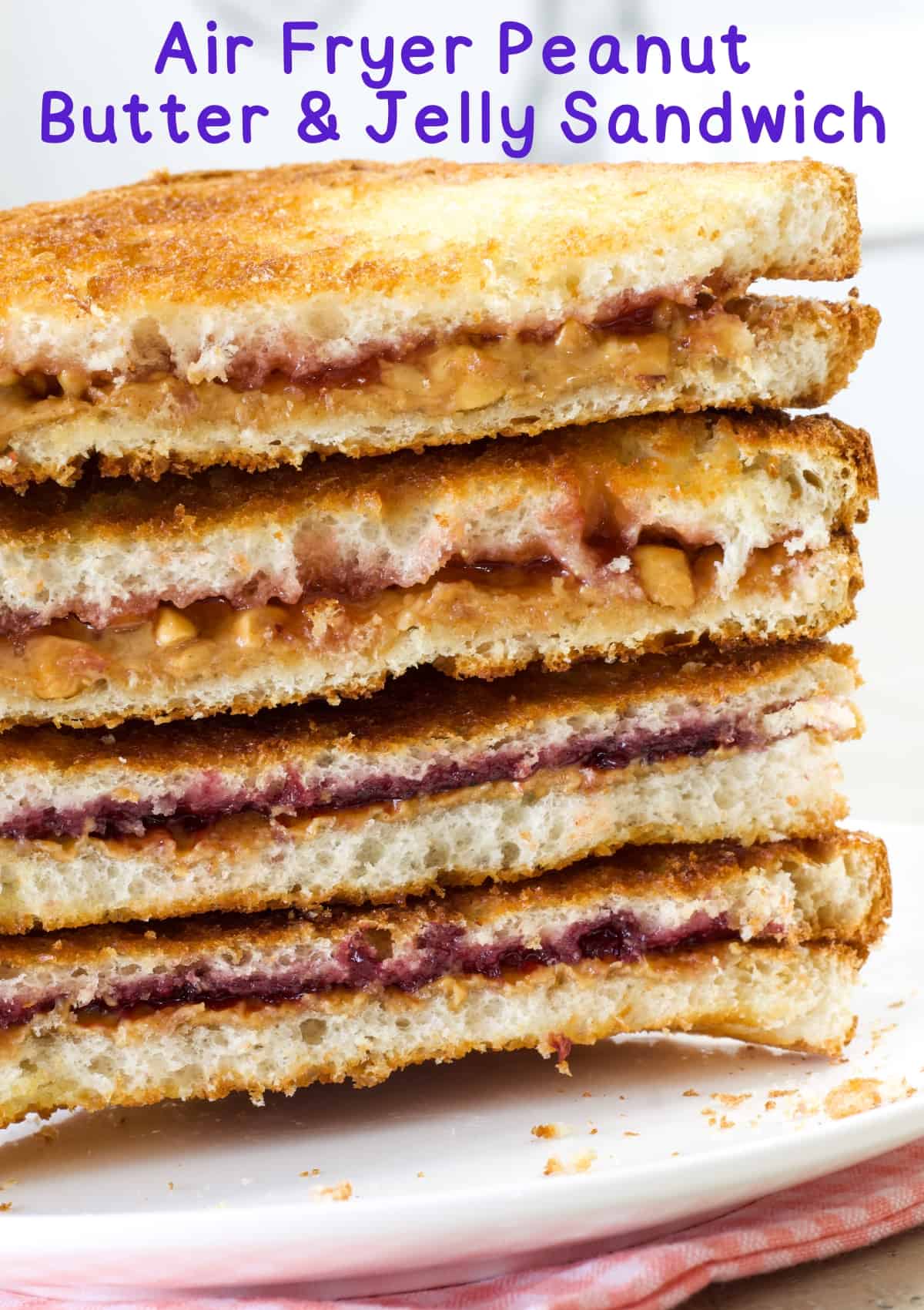 Air Fryer Peanut Butter and Jelly Sandwich recipe takes the classic sandwich to the next level. It is warm and delicious! via @mindyscookingobsession