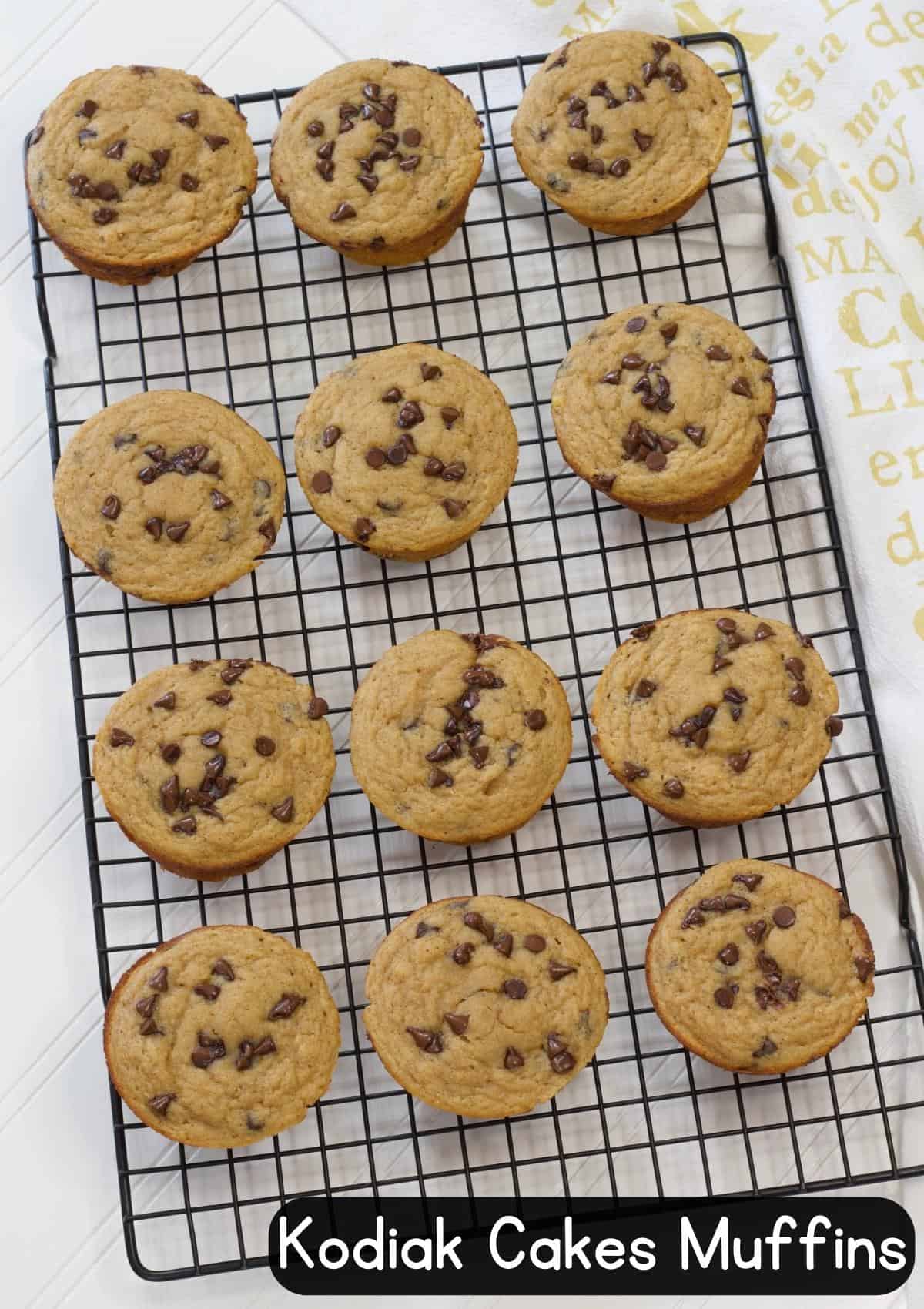 One dozen muffins on a black wire cooling rack with the recipe title in the bottom right of the image so it can be pinned on Pinterest.