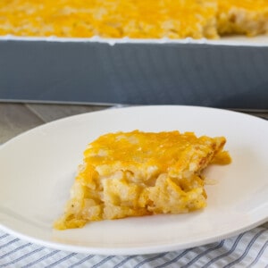 One serving of the cheesy hashbrown casserole on a white plate.