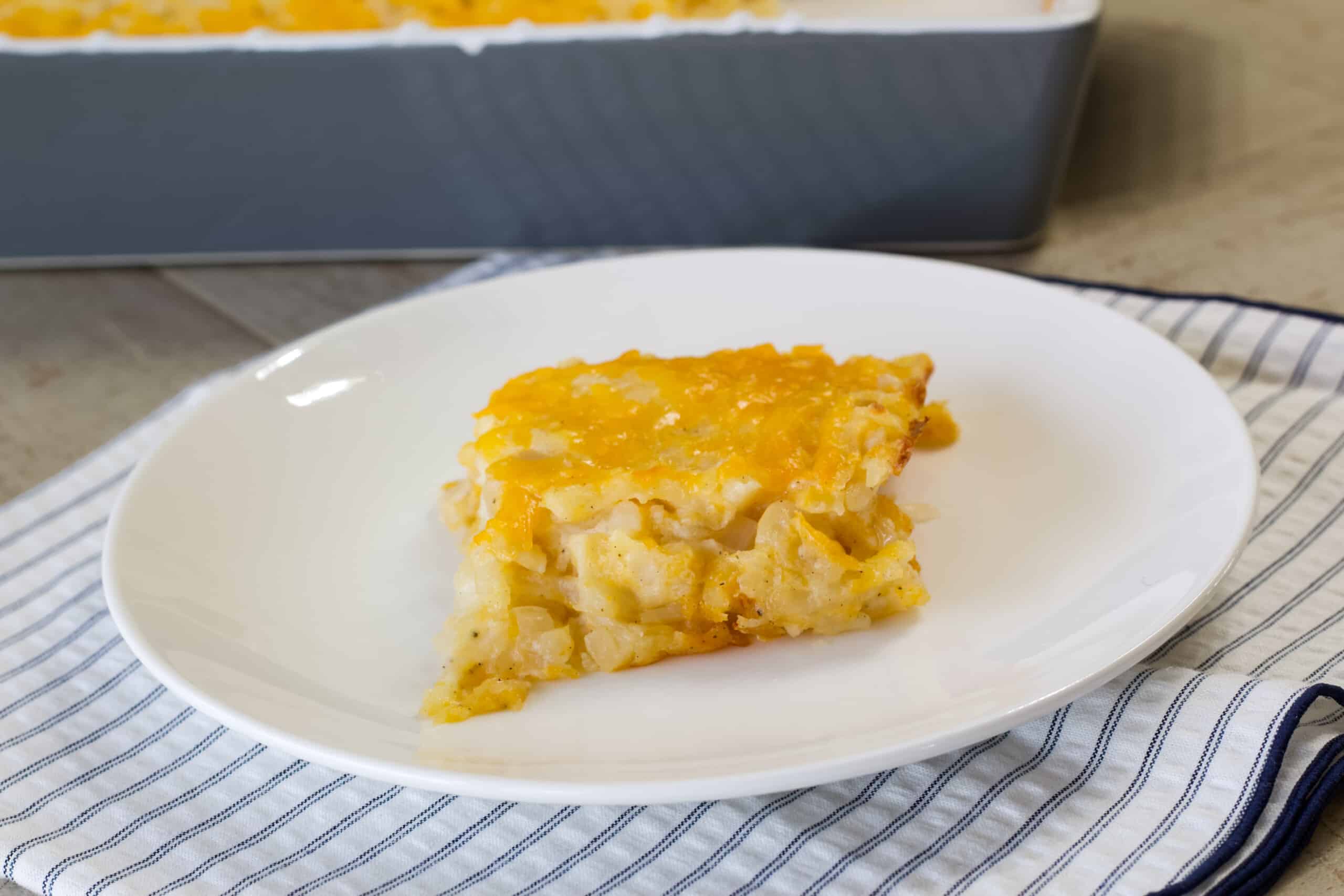 One serving of vegetarian cracker barrel hash brown casserole on a white plate.