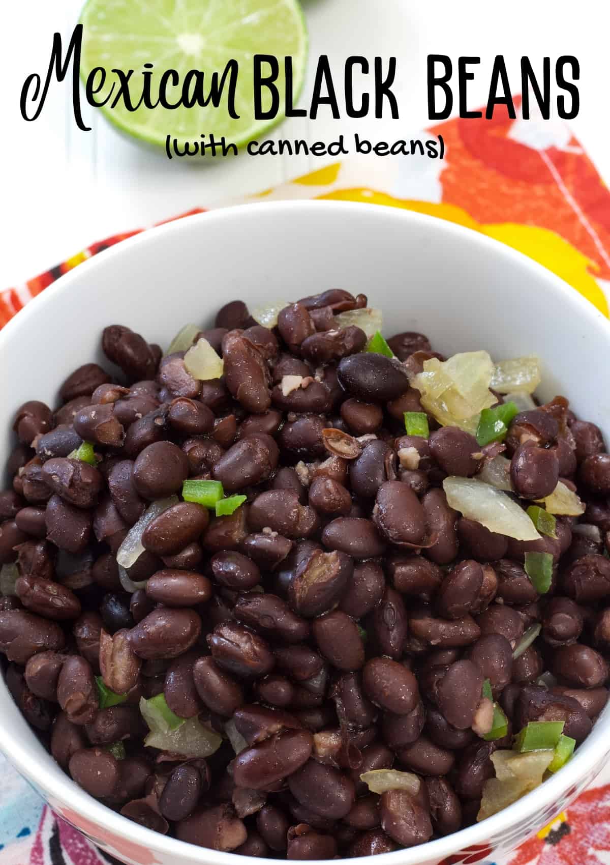 A white bowl filled with Mexican black beans with the recipe title above it so it can be pinned on Pinterest.