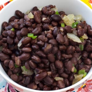 Close up of a large bowl with the entire batch of easy Mexican black beans recipe (using canned beans).