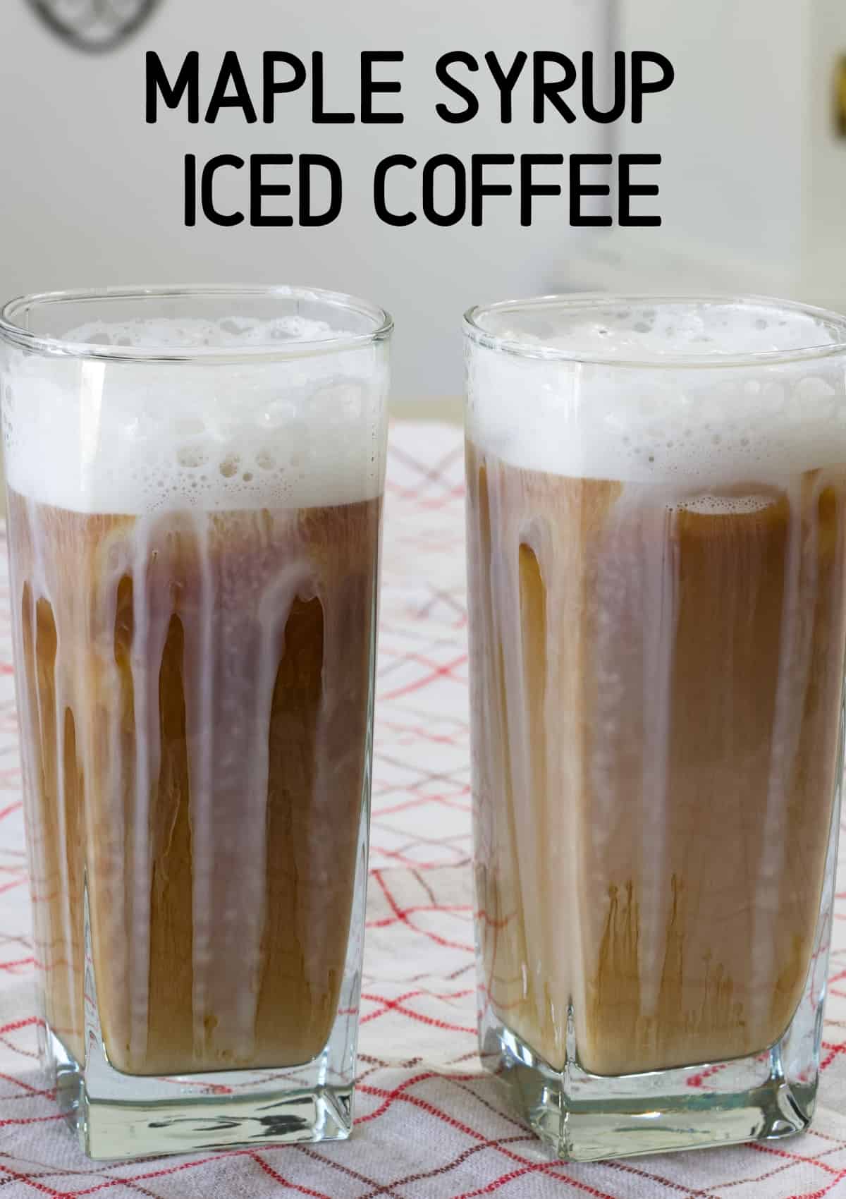Two glasses of maple syrup iced coffee and the recipe title on the top of the image so it can be pinned on Pinterest.