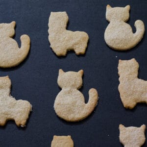 Several cat and llama cookies on a black background.