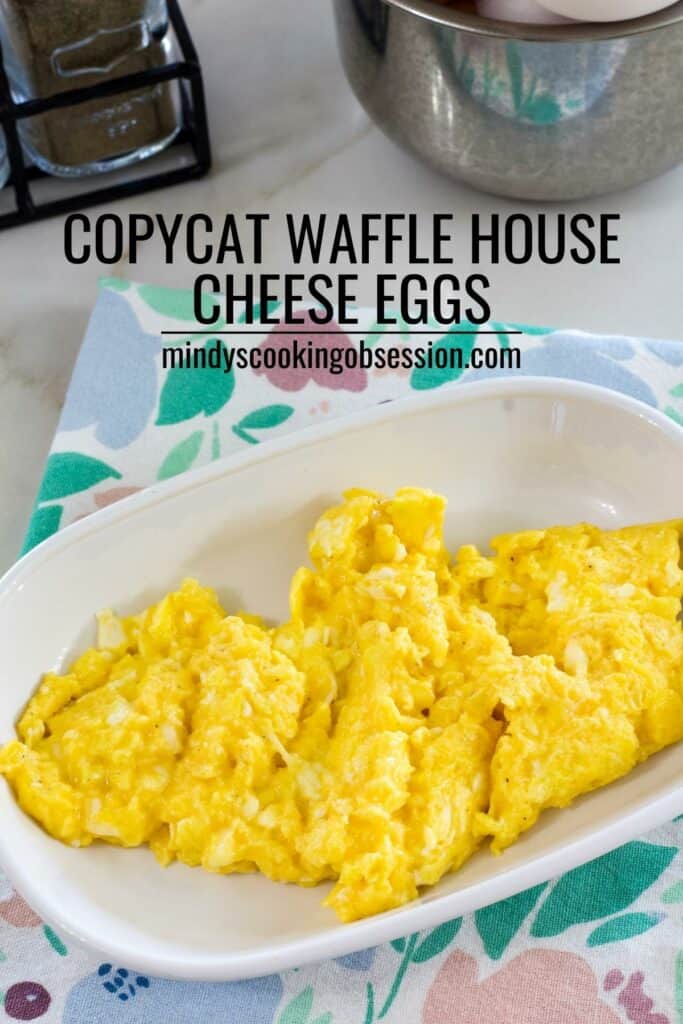 A plate of cheese eggs sitting on a pastel floral napkin with the recipe title in text so the image can be pinned.