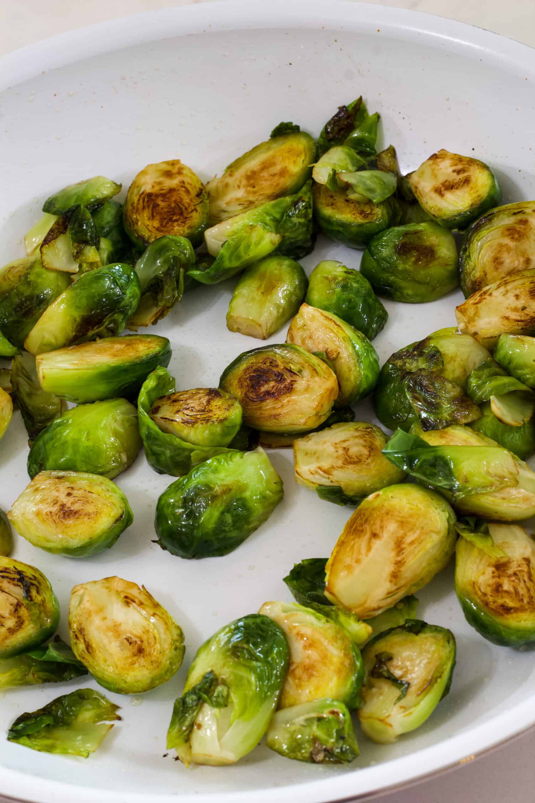 The cooked Brussels sprouts in the frying pan before the sauce is added.