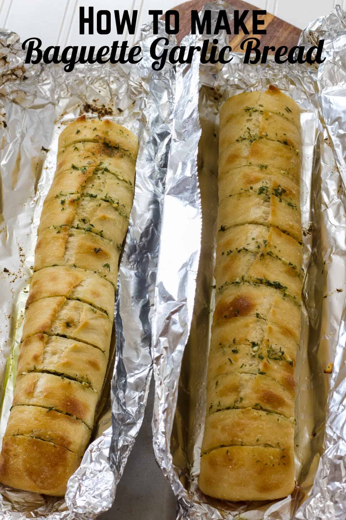 Half loaves of sliced garlic bread on aluminum foil after they came out of the oven. The recipe title is above so he image can be pinned on Pinterest.