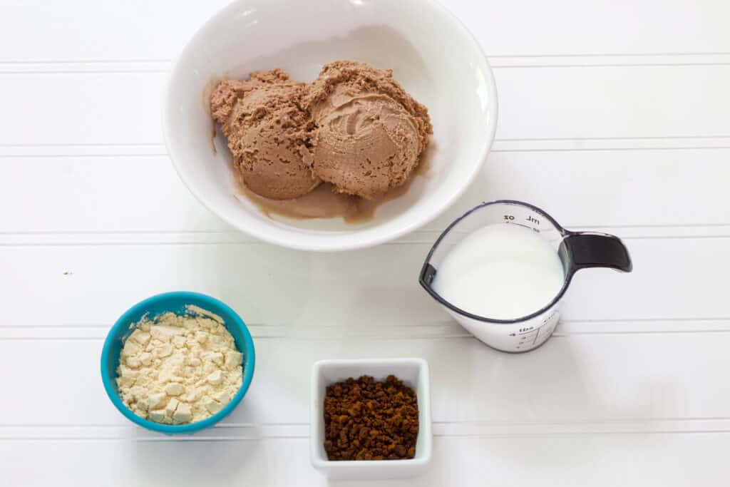 The chocolate frozen yogurt, protein powder and instant coffee in separate small bowls and the milk in a small measuring cup.