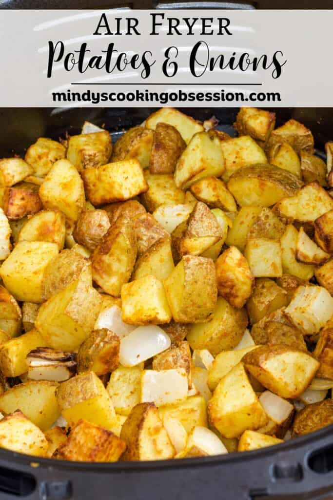 The potatoes and onions in the air fryer basket with the recipe title above it.