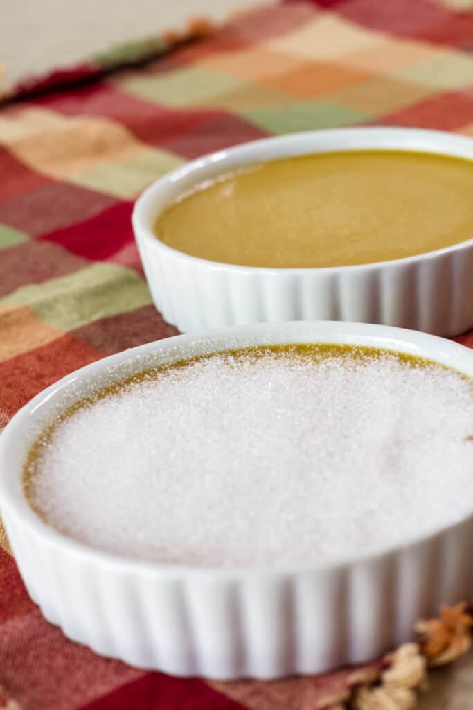 A serving if coffee creme brulee that has the sugar on top before it was torched to caramelize it.