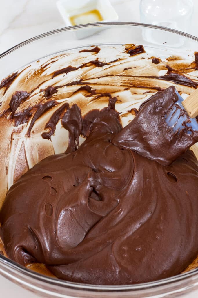 A large glass bowl full of Easy Hershey's Perfectly Chocolate Frosting Recipe.