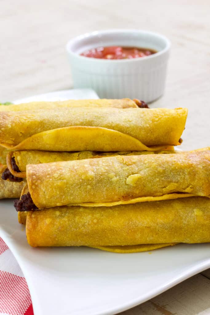 A close up showing the Easy Homemade Air Fryer Ground Beef Taquitos from the side.