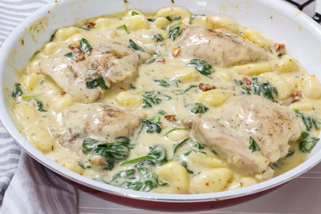 The whole skillet of Easy One Pan Creamy Chicken and Gnocchi Dinner Recipe in it.