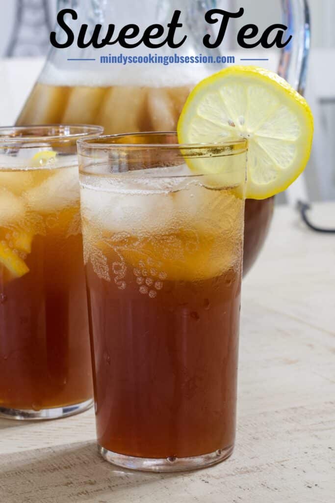 A glass of tea with a slice of lemon on the side of the glass, the words sweet tea are above it.