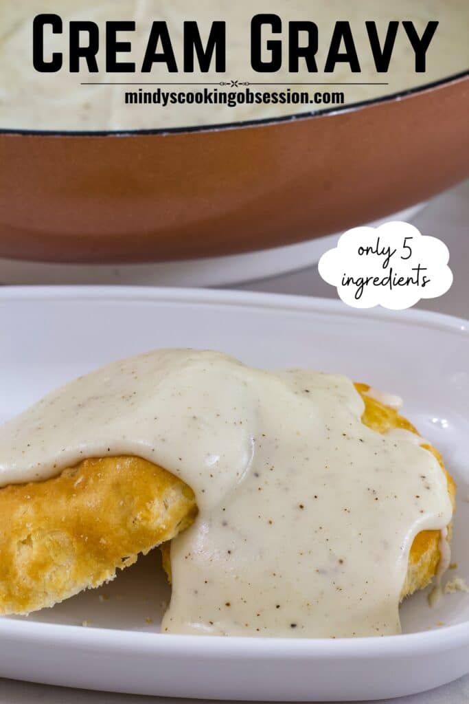 Close up view of southern white gravy on a biscuit with the recipe title on the top so it can be pinned.