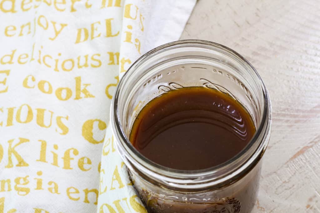 Overhead view of a mason jar with pumpkin spice coffee syrup in it.