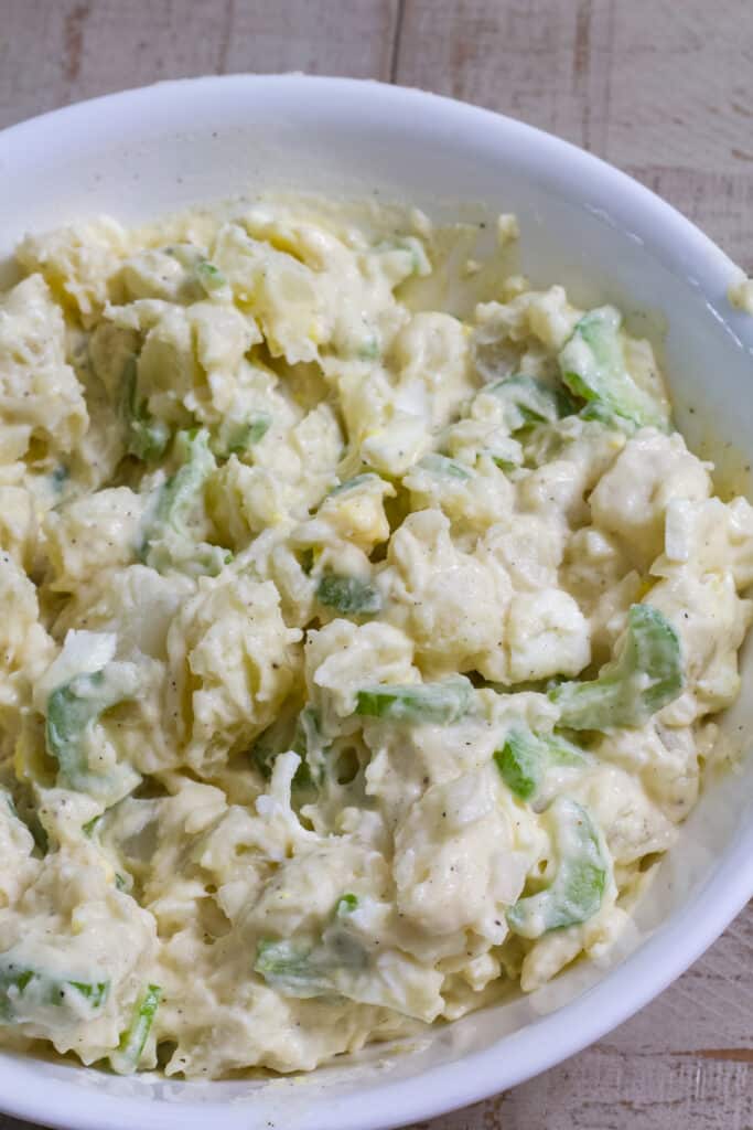 Overhead close up view of the Hellmann's Mayonnaise Original Potato Salad Recipe in a large white bowl.