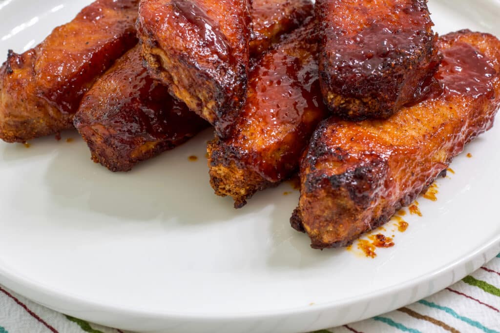 You can see just about half of six ribs on a white plate.