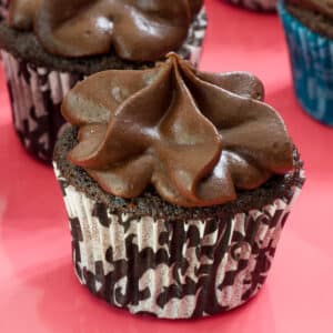 Very close up view of one cupcake that has been frosted with chocolate frosting using a star tip.