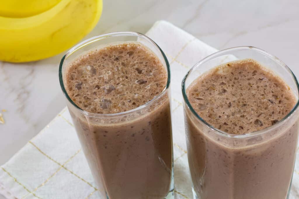 The top of two glasses of chocolate coffee smoothie.