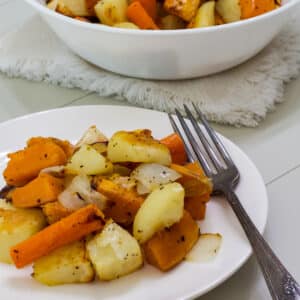 A serving of vegetables on a white plate with a fork on the edge of the plate.