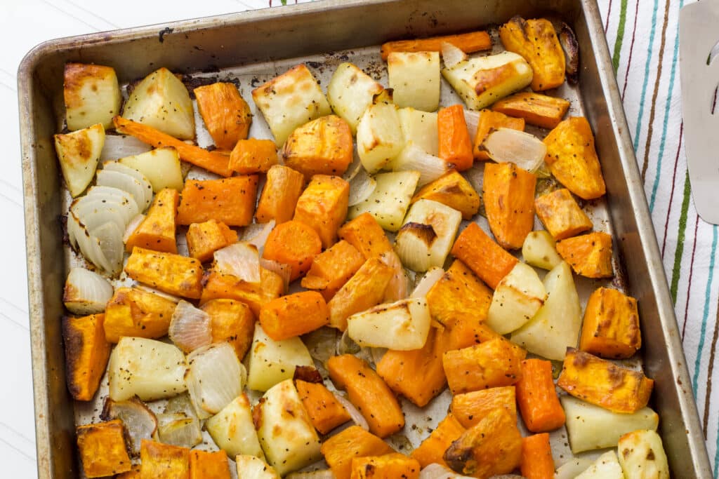 The top half of the sheet pan with Easy Oven Roasted Root Vegetables on it after they have been roasted.