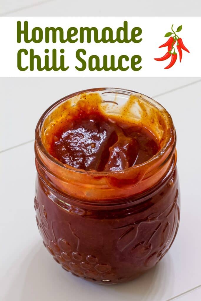 A jar filled with homemade chili sauce with the recipe title in text above it.