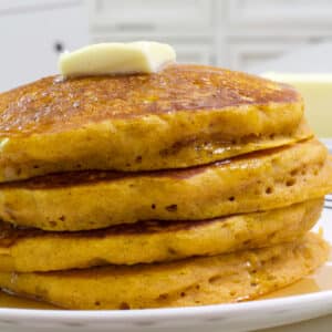 Close up view of the stack of four pumpkin pancakes.