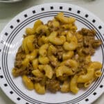 Overhead view of plate with one serving of homemade hamburger helper cheeseburger macaroni.