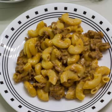 Overhead view of plate with one serving of homemade hamburger helper cheeseburger macaroni.