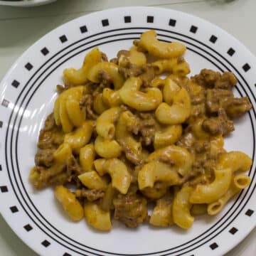 Overhead view of plate with one serving of homemade hamburger helper cheeseburger macaroni.