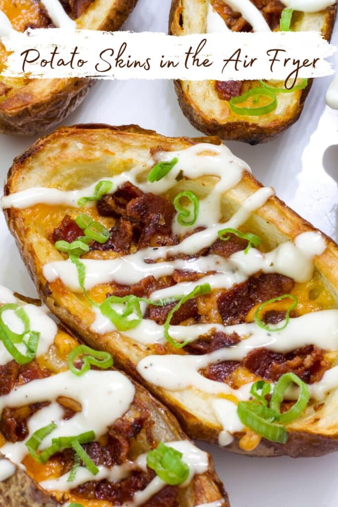 Several air fried crispy loaded potato skins on a plate, one is in full view.