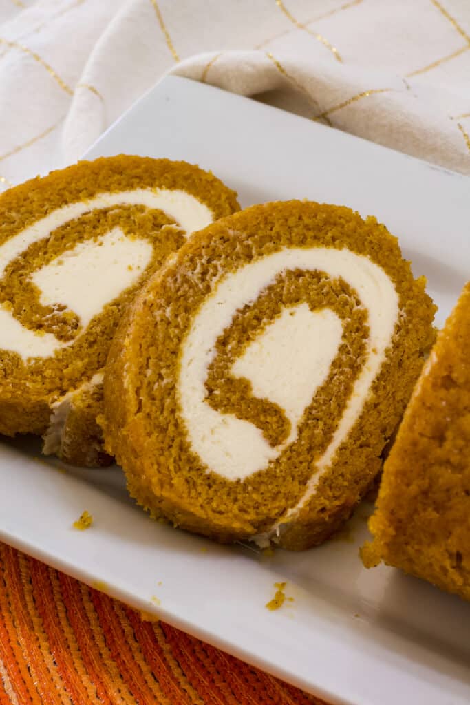 Two slices of libby's pumpkin roll on a white plate.