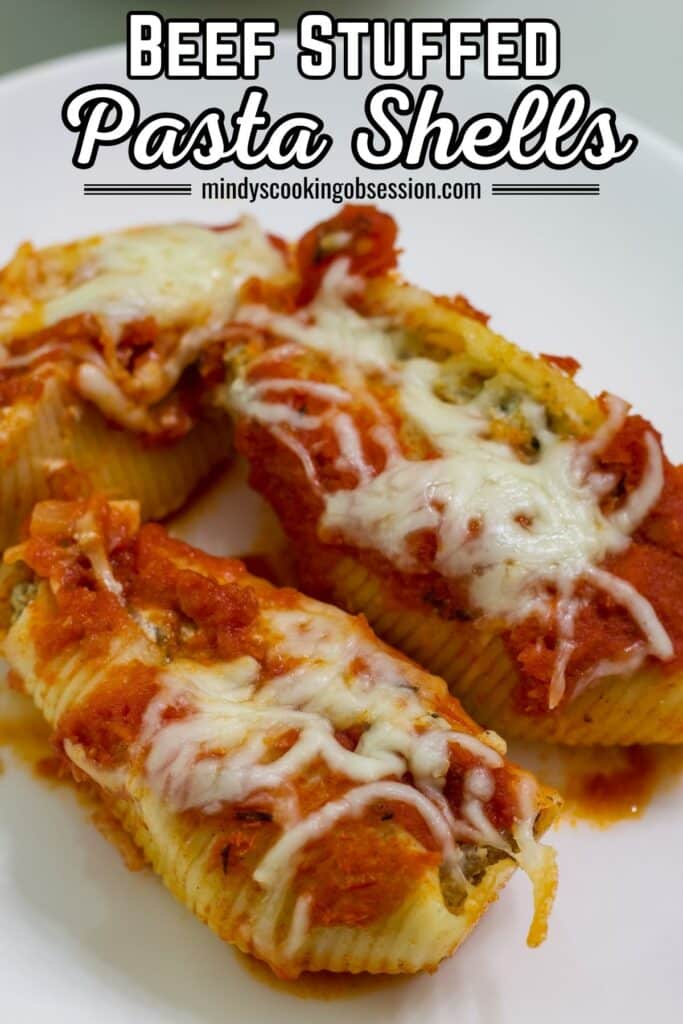 Close up of three stuffed shells on a white plate with the recipe title in text above them.