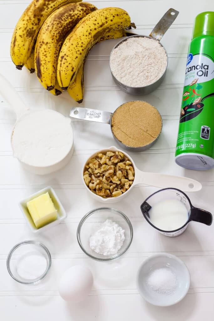 All of he ingredients needed to make The Best Weight Watchers banana bread recipe measured out and sitting on a white table.