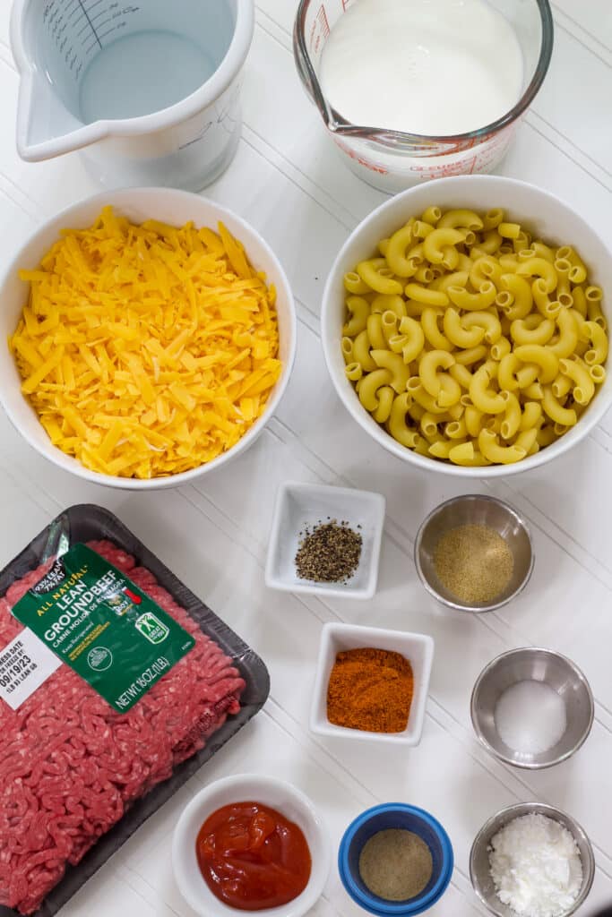 All of the ingredients measured out that is needed to make homemade hamburger helper cheeseburger macaroni.