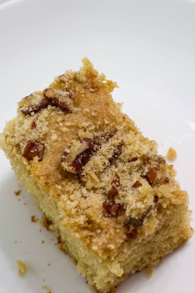 Top view of one piece of cowboy coffee cake on a white plate.