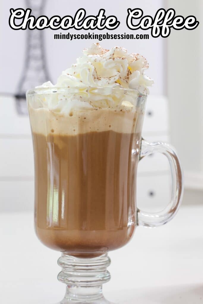 A cup of chocolate coffee topped with whipped cream, the recipe title is in text at the top of the image.
