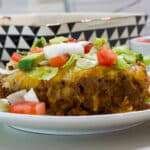 Close up side angle of one serving of Easy Taco Salad Casserole with Beef & Beans with toppings.