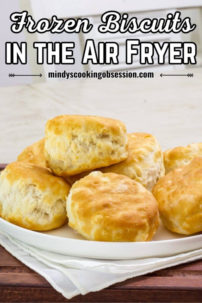 A plate full of air fryer frozen biscuits on a serving tray, the post title is at the top in text.